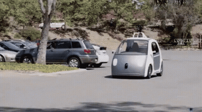 Small Silver Car Driving Down Road With Other Cars GIF