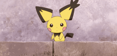 Small Yellow And Black Cartoon Sitting On Brick Wall GIF