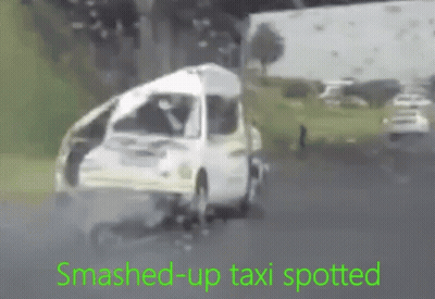 Smashed Up Taxi Driving Down Road GIF