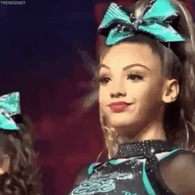 Smiling Cheerleader With Blue Bow GIF