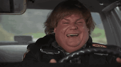 Smiling Chris Farley On Wheels GIF
