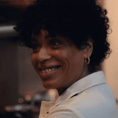 Smiling Curly Hair Woman In White Shirt And Hoop Earrings GIF