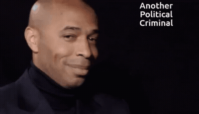 Smiling Man Black Turtleneck Saying Another Political Criminal GIF