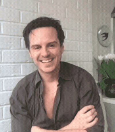 Smiling Man Crossed Arms Brick Wall GIF