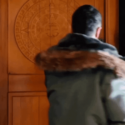 Smiling Man Going Out Of Wooden Door GIF