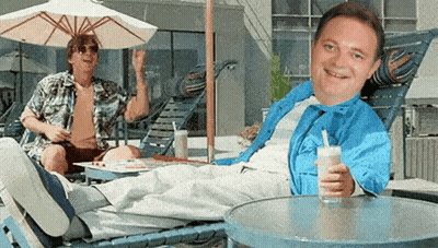 Smiling Man Holding Drink, Man Standing Behind GIF