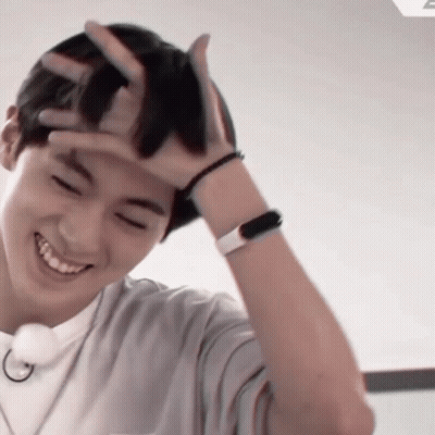 Smiling Man Holding Hand To Head GIF