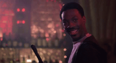 Smiling Man Holding Sword In Bar GIF