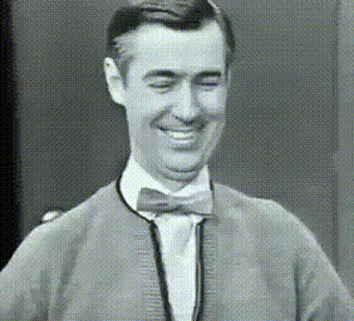Smiling Man In Bow Tie And Sweater GIF