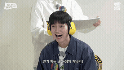 Smiling Man In Ear Muffs And Man Holding Paper GIF