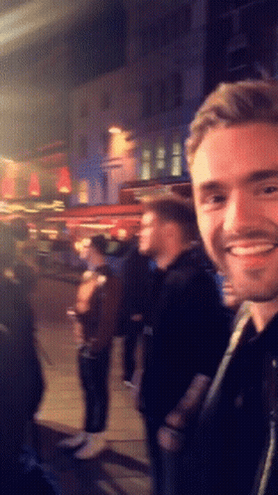 Smiling Man In Front Of Crowd GIF