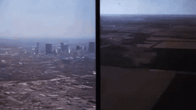 Smiling Man In Front Of Running Poster GIF