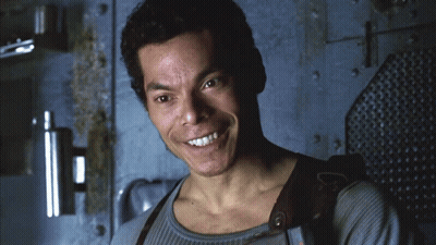 Smiling Man In Front Of Wall GIF