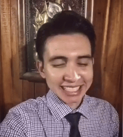 Smiling Man In Plaid Shirt And Tie Taking Selfie GIF