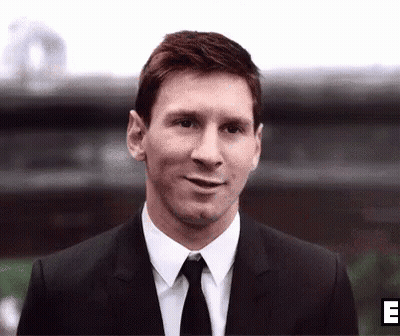 Smiling Man In Suit And Tie Outside Building GIF