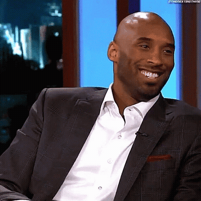 Smiling Man In Suit Looking At Camera GIF