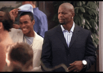 Smiling Man In Suit Next To Man With Hat GIF