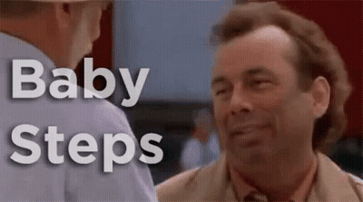 Smiling Man In Suit Talking To Man In Hat GIF