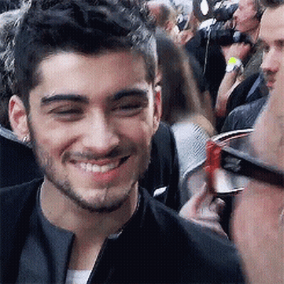 Smiling Man With Beard And Glasses In Front Of Crowd GIF