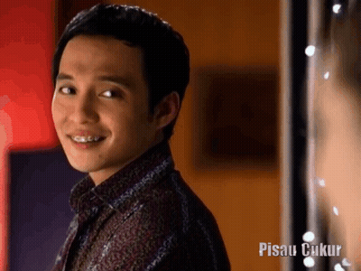 Smiling Man With Braces In Front Of Pisau Cukup Sign GIF