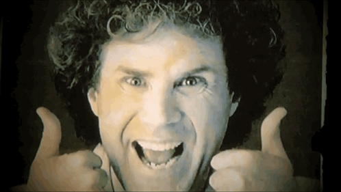 Smiling Man With Curly Hair Giving Thumbs Up GIF