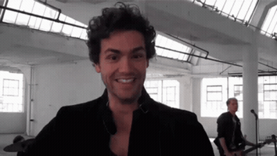 Smiling Man With F On Shirt Black And White GIF