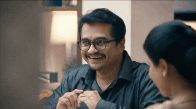 Smiling Man With Glasses And Mustache Talking To Woman GIF