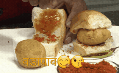 Smiling Person Holding Sandwich With Sauce GIF