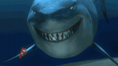 Smiling Shark With Clown Fish Behind GIF