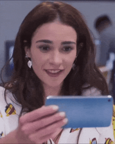 Smiling Woman Holding Cell Phone GIF