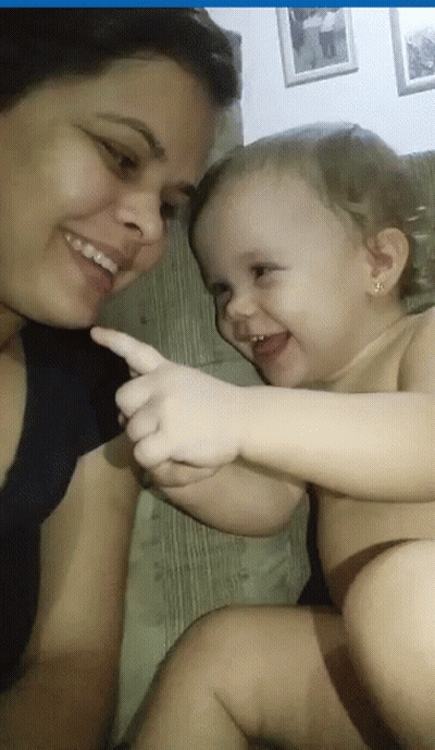 Smiling Woman Holding Pointing Baby GIF