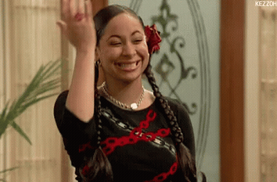 Smiling Woman In Black Dress With Red Flower Waving GIF