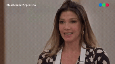 Smiling Woman In Black-White Floral Shirt And Apron GIF