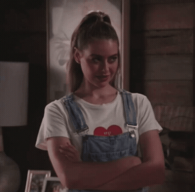 Smiling Woman In Earrings And Black Shirt GIF