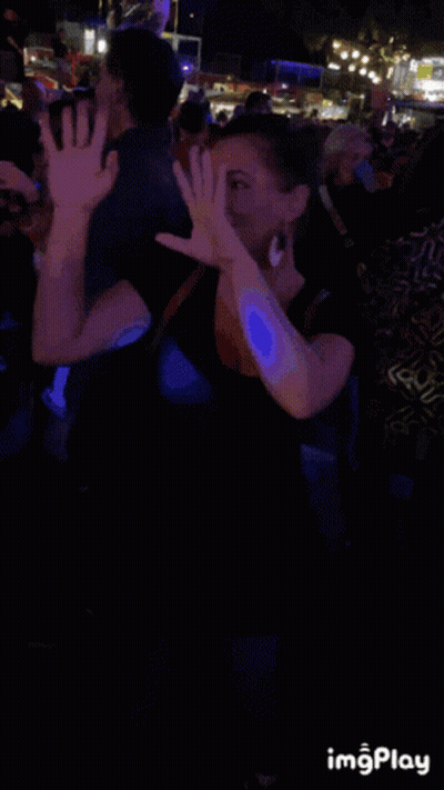 Smiling Woman In Front Of Crowd GIF