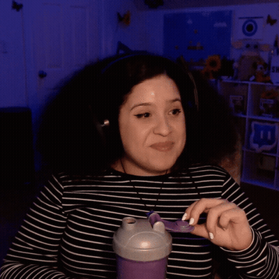 Smiling Woman In Headphones Holding Purple Container GIF