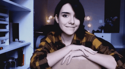 Smiling Woman In Plaid Shirt GIF