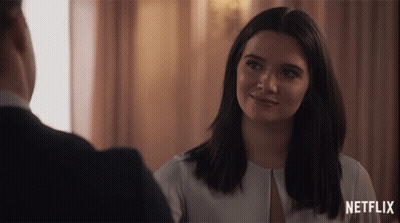 Smiling Woman Looking At Man With Netflix Logo GIF