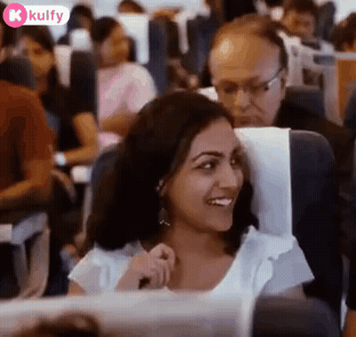 Smiling Woman Sitting On Airplane GIF