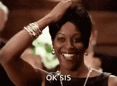 Smiling Woman Touching Hair With Necklace And Bracelets GIF