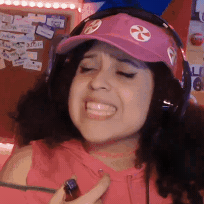 Smiling Woman With Headphones And Pink Hat Holding Lighter GIF