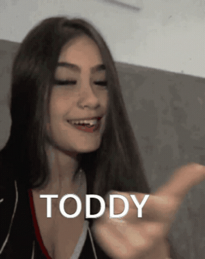 Smiling Woman With Long Hair Pointing Toddy GIF
