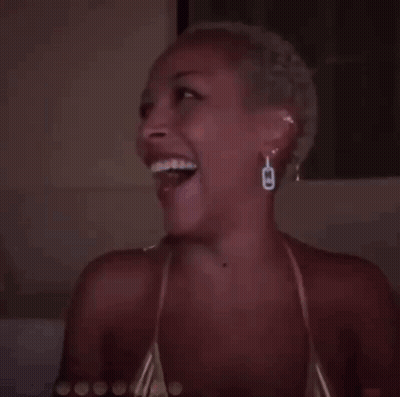 Smiling Woman With Wrist Tattoo In Bikini GIF