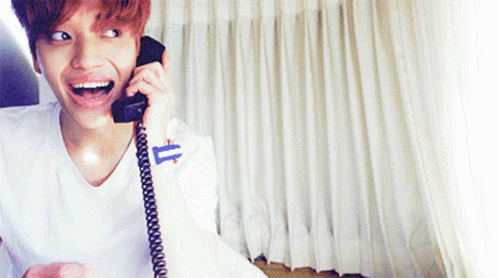 Smiling Young Man Talking On Phone GIF