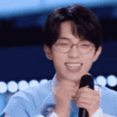 Smiling Young Man With Glasses And Microphone GIF