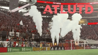 Smoke Coming Out Of A Soccer Field That Says Atl Uto GIF