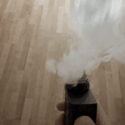 Smoke Is Coming Out Of A Black Object On A Wood Floor GIF
