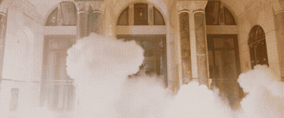 Smoke Is Coming Out Of A Building With Arched Windows GIF