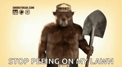 Smokey The Bear Is Wearing A Hat And Holding A Shovel And Says `` Stop Peeing On My Lawn '' . GIF