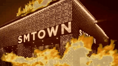 Smtown Is Written On The Side Of A Building With Flames Coming Out Of It GIF